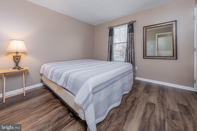 bedroom featuring baseboards and wood finished floors