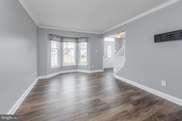 unfurnished living room featuring dark wood-style flooring, crown molding, stairway, and baseboards