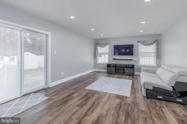 living room featuring recessed lighting, baseboards, and wood finished floors