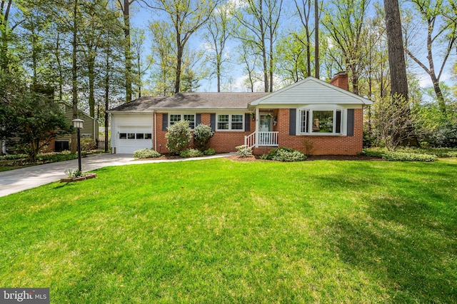 ranch-style house featuring concrete driveway, a chimney, a front yard, an attached garage, and brick siding