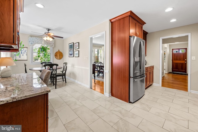kitchen with a ceiling fan, a healthy amount of sunlight, stainless steel fridge with ice dispenser, and recessed lighting