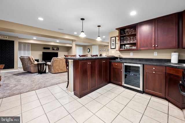 kitchen with beverage cooler, dark countertops, light colored carpet, open floor plan, and a peninsula