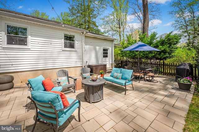 view of patio with outdoor lounge area and fence