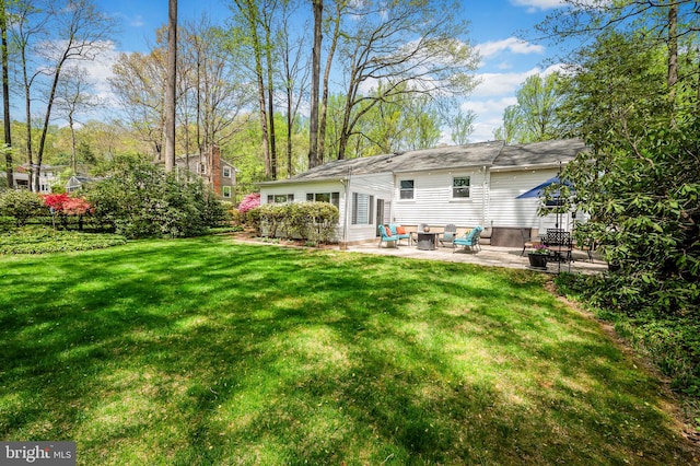 rear view of house with a patio, an outdoor hangout area, and a yard