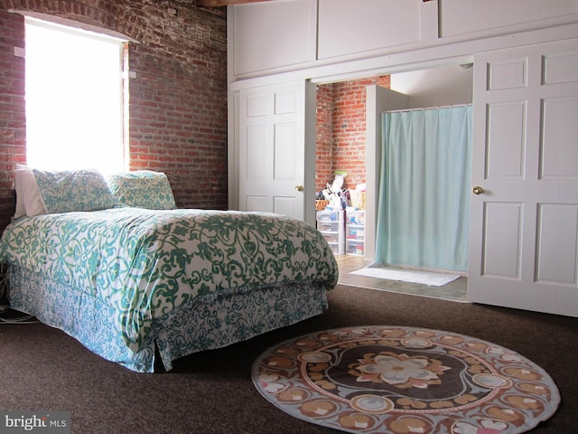 bedroom with brick wall and access to outside