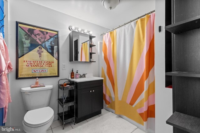 bathroom featuring tile patterned floors, toilet, and vanity