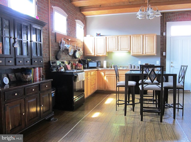 kitchen featuring beamed ceiling, black appliances, light brown cabinets, brick wall, and dark wood-style flooring