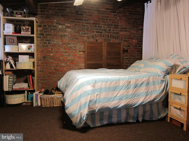 carpeted bedroom with brick wall