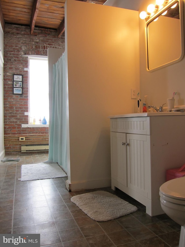 bathroom featuring beamed ceiling, toilet, brick wall, wood ceiling, and vanity