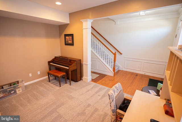 interior space with a wainscoted wall, recessed lighting, carpet floors, a decorative wall, and decorative columns