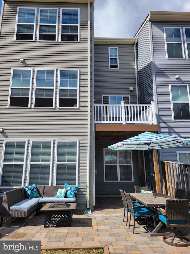 back of house with a patio area, outdoor dining space, and outdoor lounge area