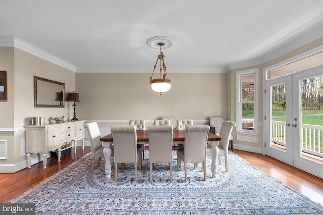 10855 Bethesda Church Rd, Damascus, MD 20872 - dining space with french doors, crown molding, wood finished floors, and baseboards