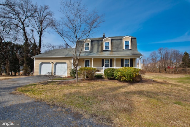 colonial inspired home with driveway, a garage, a front lawn, and a porch