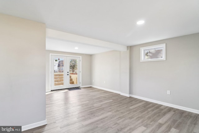 empty room featuring recessed lighting, french doors, baseboards, and wood finished floors