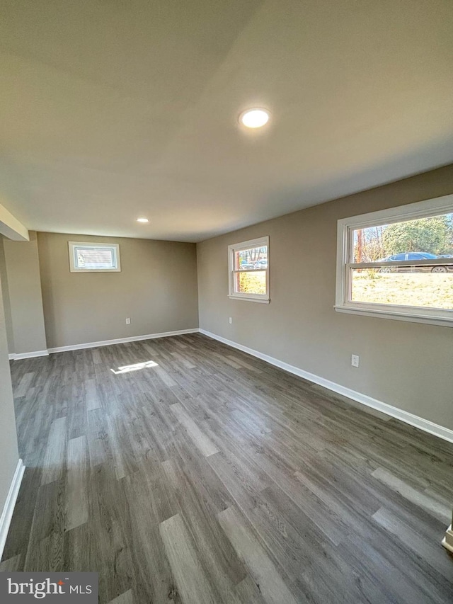 unfurnished room with recessed lighting, baseboards, and dark wood-type flooring