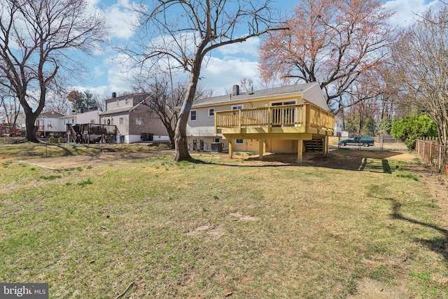 view of yard featuring central AC unit, a deck, and fence