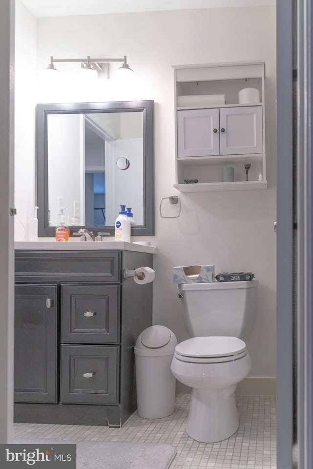 half bathroom with vanity and toilet