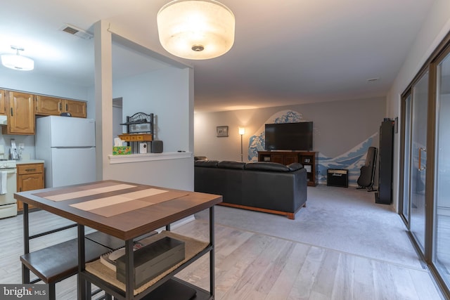 dining room with light wood-style flooring and visible vents