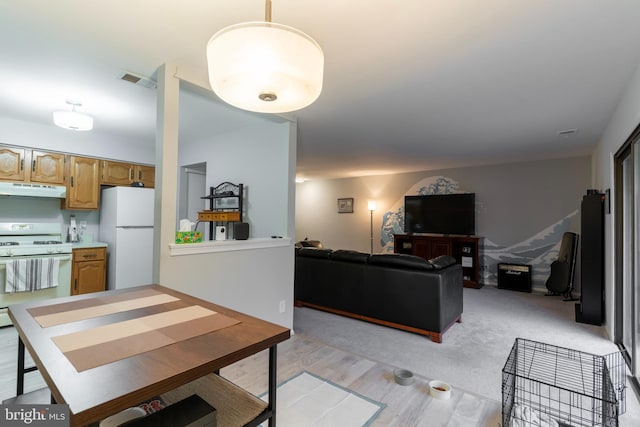 dining space featuring light wood-style flooring and visible vents