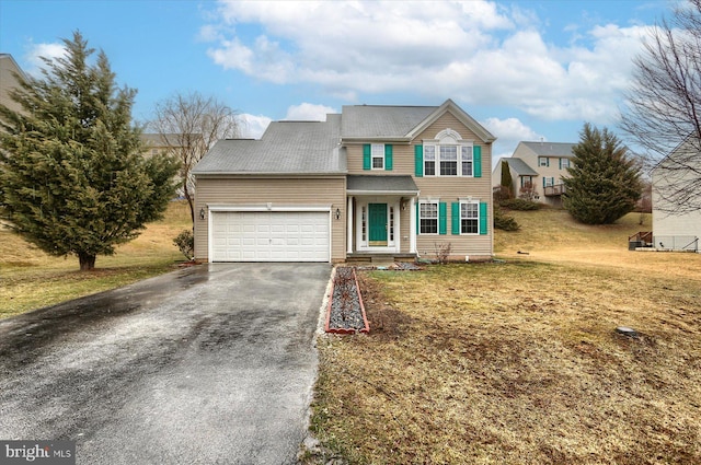 traditional-style home featuring aphalt driveway, a front lawn, and an attached garage