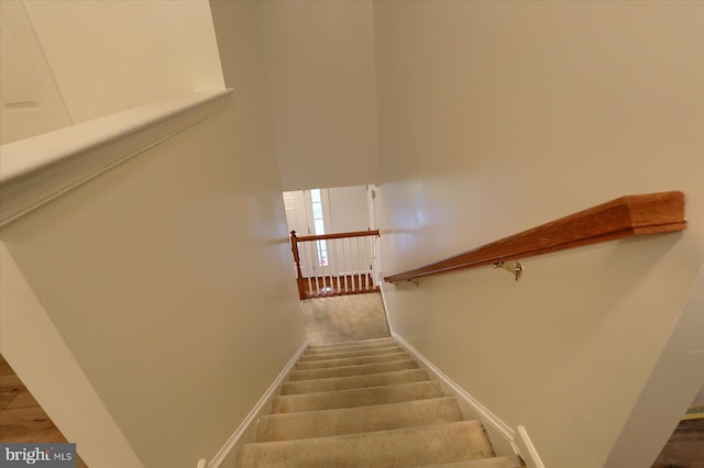 staircase featuring baseboards