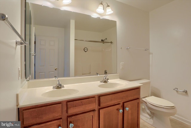 full bath featuring double vanity, walk in shower, a sink, and toilet