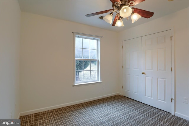 unfurnished bedroom featuring a ceiling fan, a closet, visible vents, and baseboards