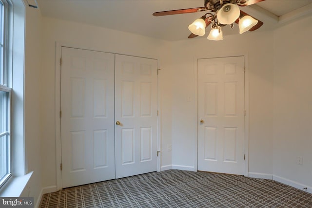 unfurnished bedroom with a closet, a ceiling fan, and baseboards