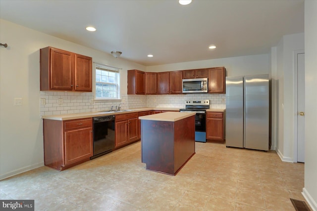 kitchen featuring baseboards, backsplash, stainless steel appliances, light countertops, and a sink