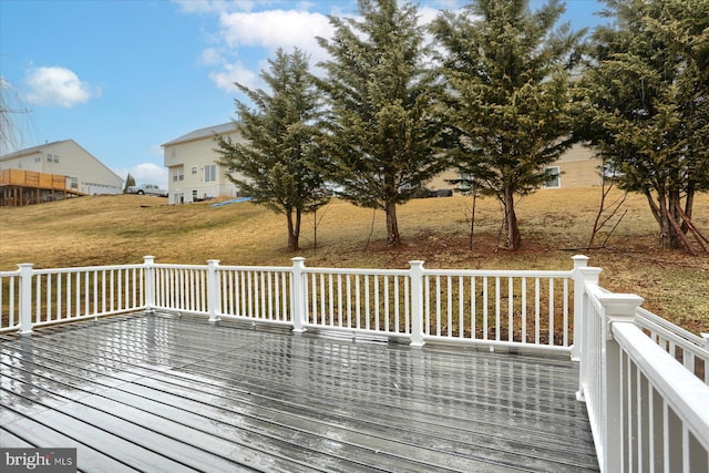 wooden terrace with a lawn