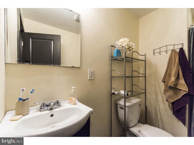 bathroom with a sink and toilet