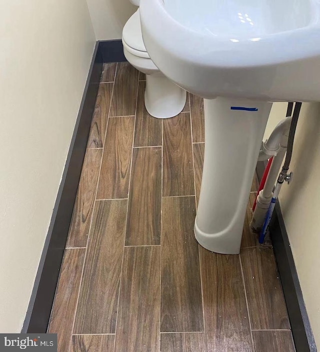 interior space featuring baseboards and wood tiled floor