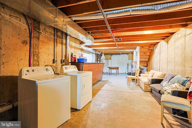 unfinished basement featuring washer and clothes dryer