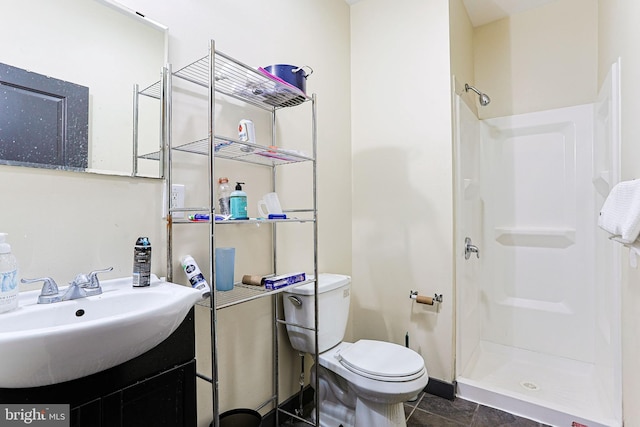 full bath with vanity, toilet, and a shower stall