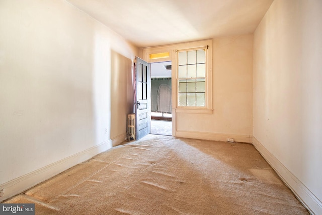 empty room featuring carpet floors and baseboards