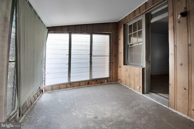 interior space featuring wooden walls and a healthy amount of sunlight