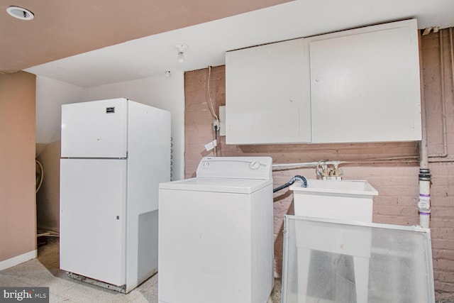 washroom featuring washer / dryer, concrete block wall, and laundry area