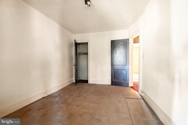 unfurnished bedroom with carpet, a closet, and baseboards