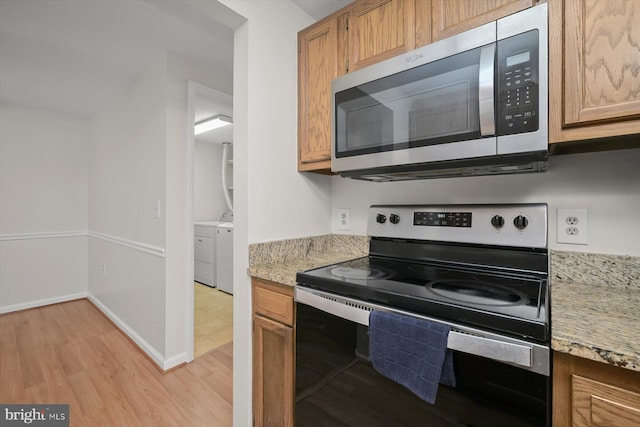 kitchen featuring light stone countertops, light wood-style floors, baseboards, and stainless steel appliances