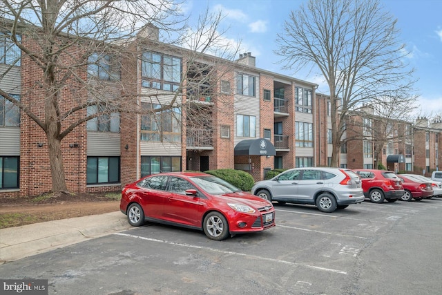 view of property featuring uncovered parking