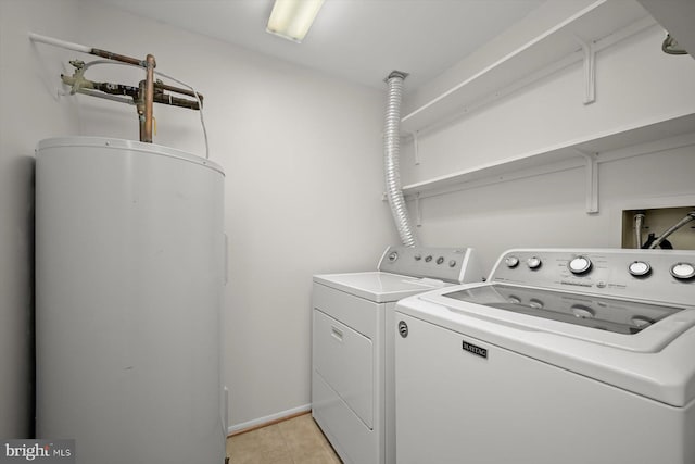 laundry room with laundry area, water heater, baseboards, and separate washer and dryer