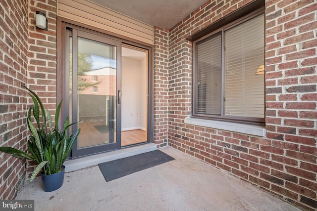 entrance to property with brick siding