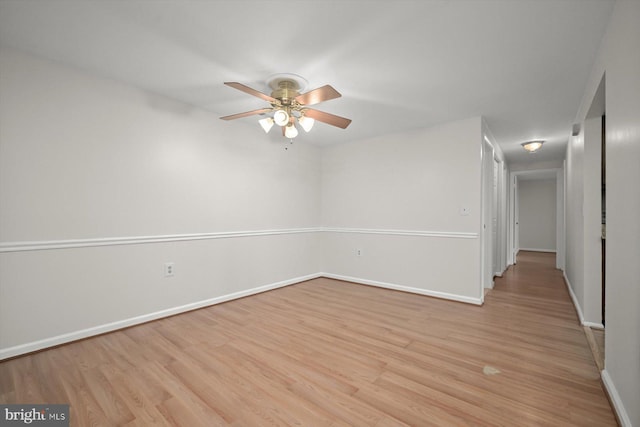 unfurnished room with light wood-type flooring, ceiling fan, and baseboards