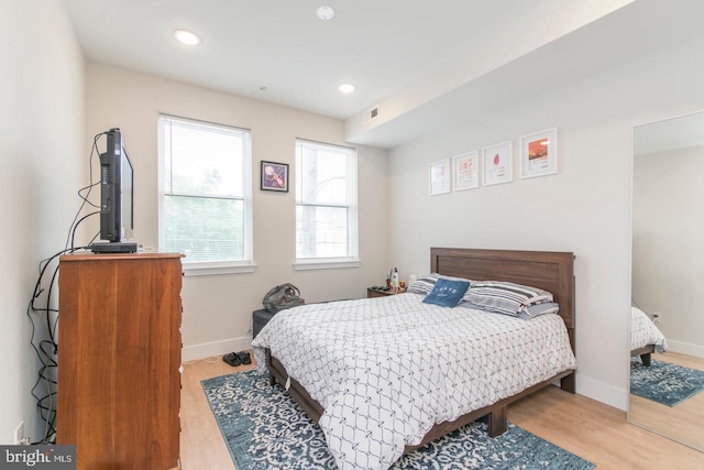 bedroom with light wood-style flooring, baseboards, and recessed lighting