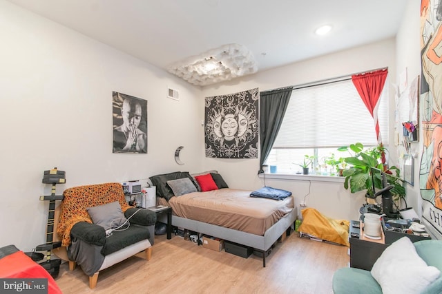 bedroom featuring visible vents and wood finished floors