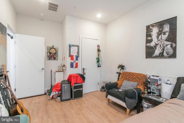 bedroom with wood finished floors and visible vents