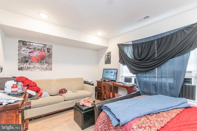 bedroom featuring wood finished floors, visible vents, and recessed lighting