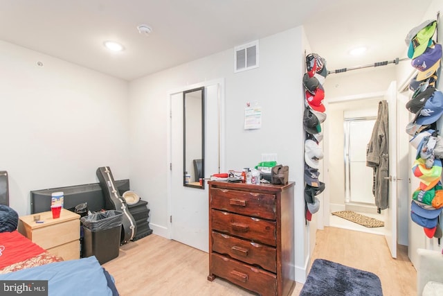 bedroom with wood finished floors, visible vents, and recessed lighting