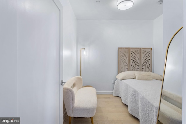 bedroom featuring light wood-style flooring and baseboards