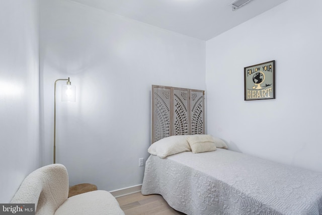 bedroom featuring light wood-type flooring and visible vents